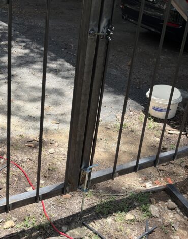 Leaning steel fence post showing common fence problem in Austin Texas yard