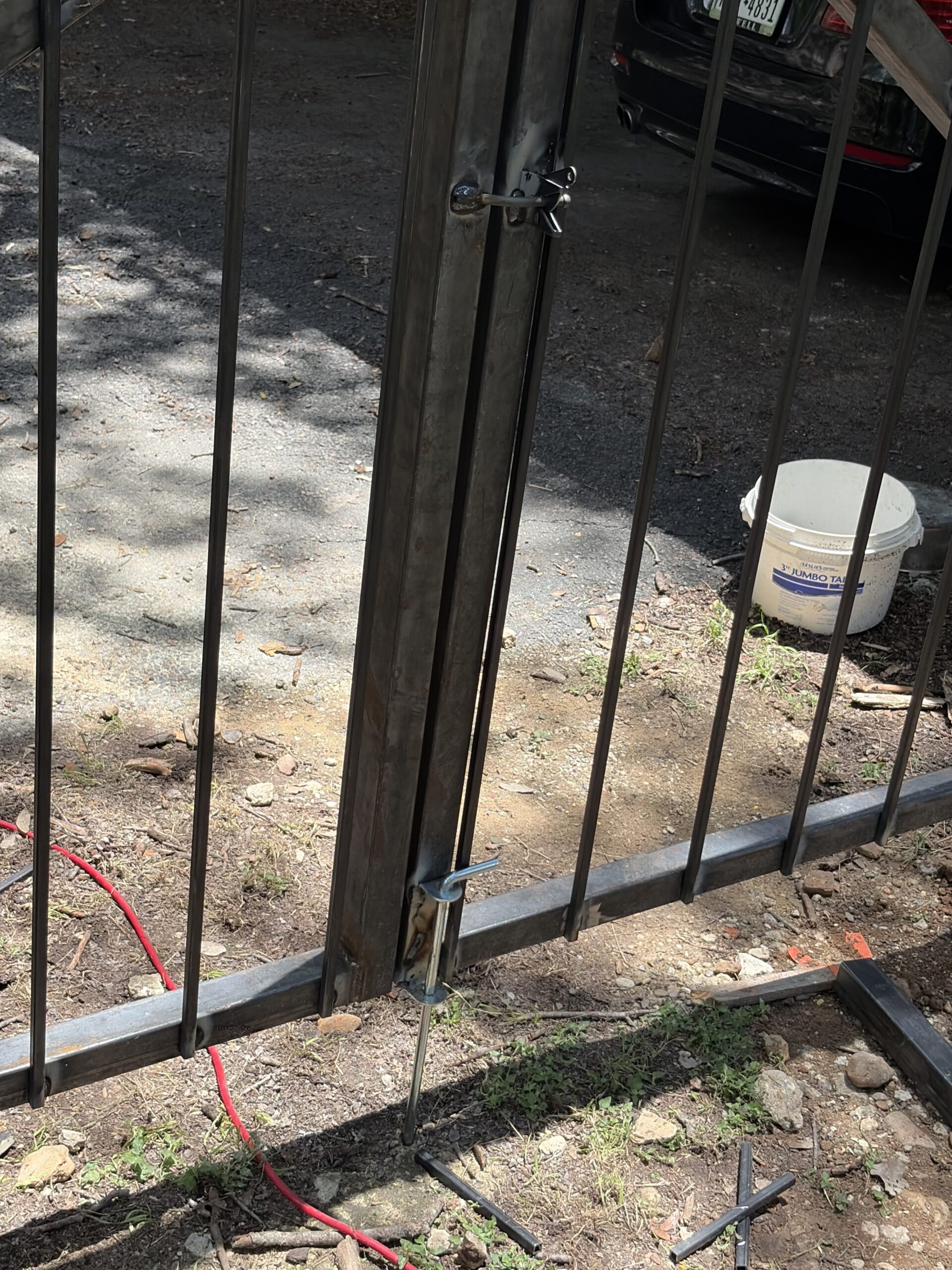 Leaning steel fence post showing common fence problem in Austin Texas yard