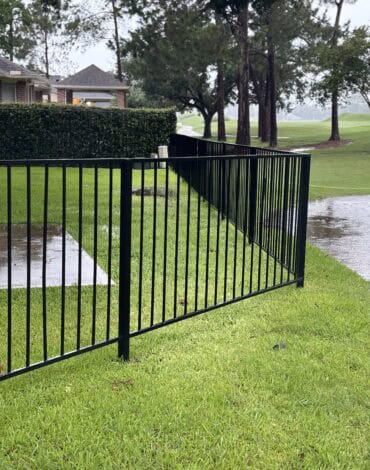 Black steel fence panels installed along a residential property in Austin Texas